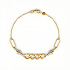 Gold bracelet with chain design and beads on a white background