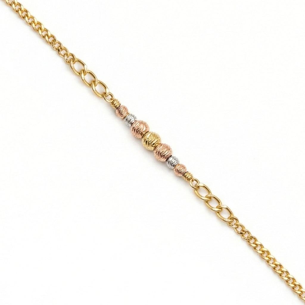 Gold chain bracelet with three different gold tones on a white background