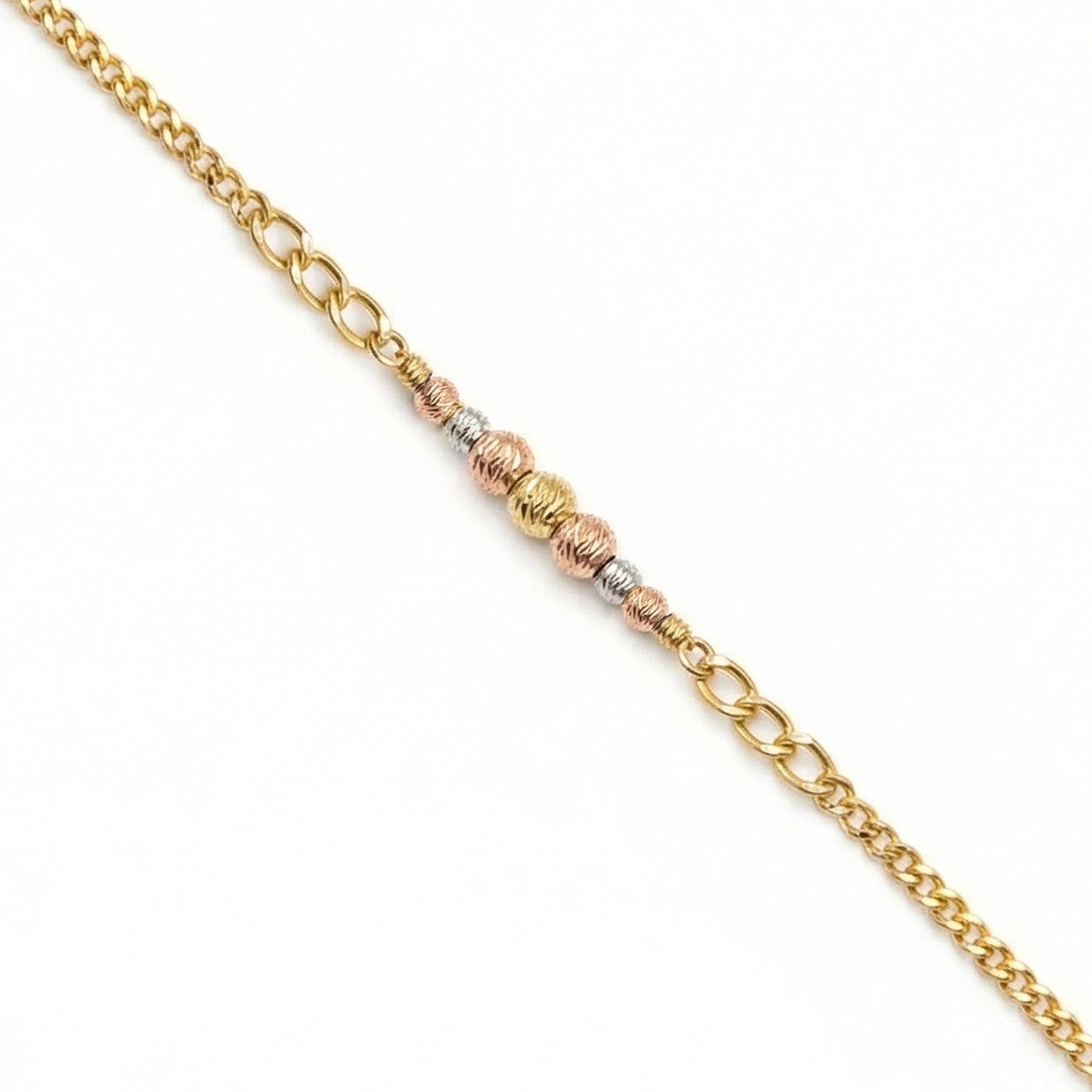 Gold chain bracelet with three different gold tones on a white background