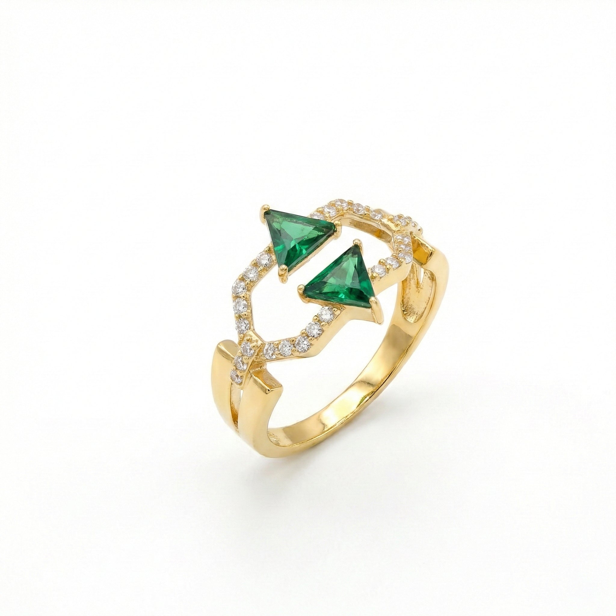 Gold ring with green gemstones on a white background