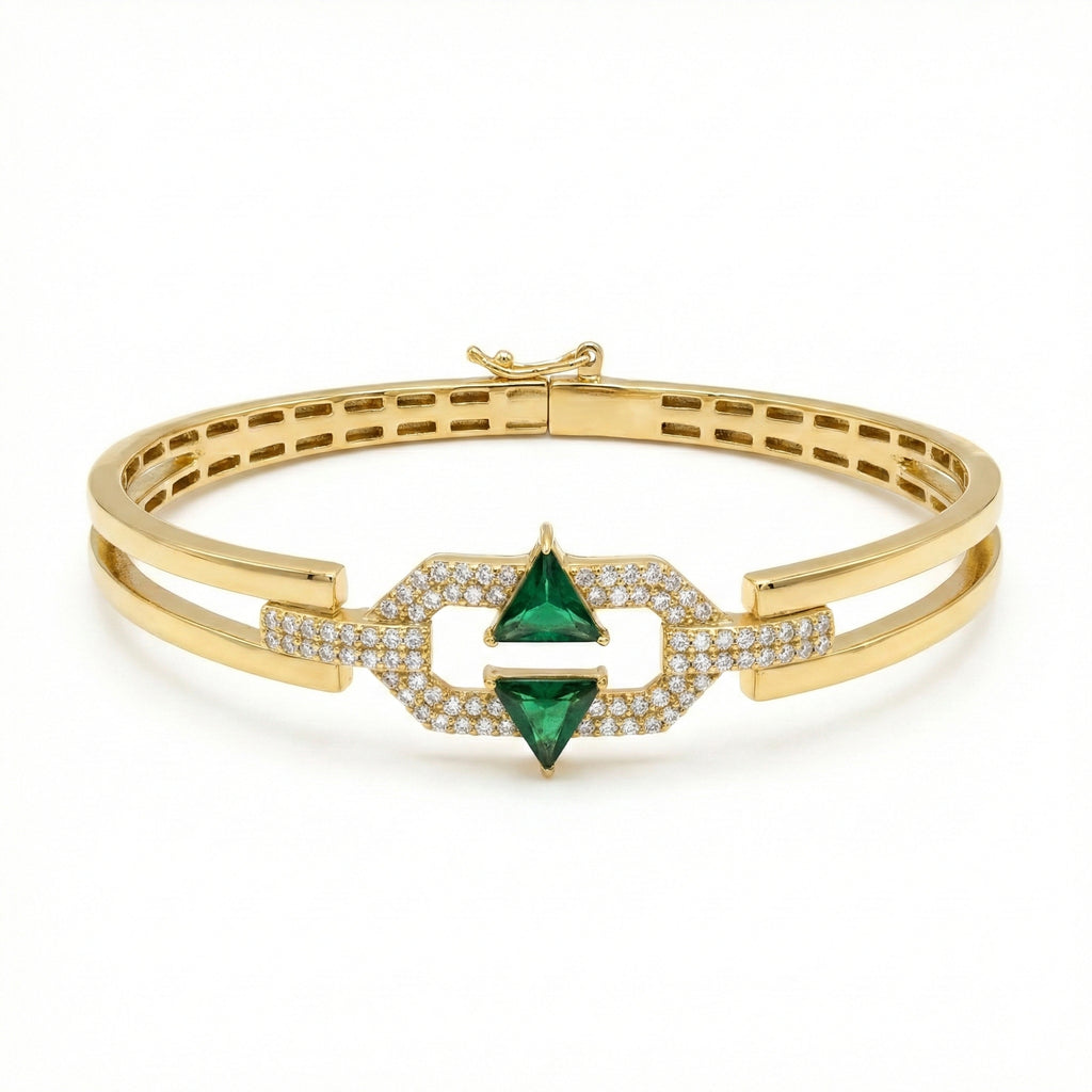 Gold bracelet with green gemstone and diamond accents on a white background