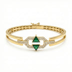Gold bracelet with green gemstone and diamond accents on a white background