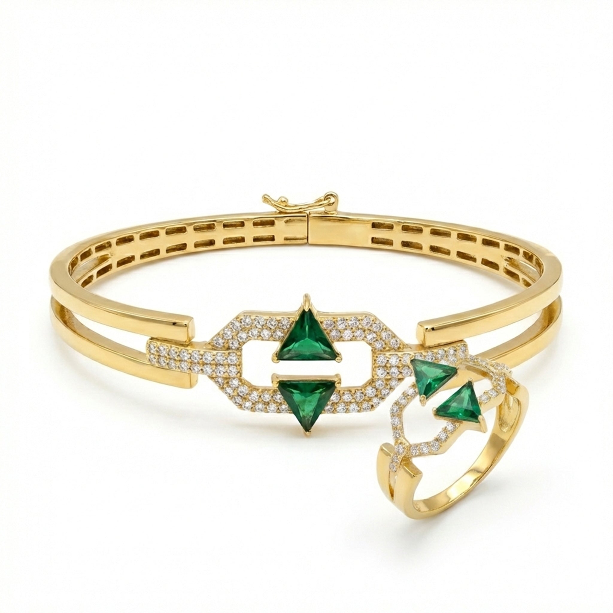 Gold bracelet and ring with green gemstones on a white background