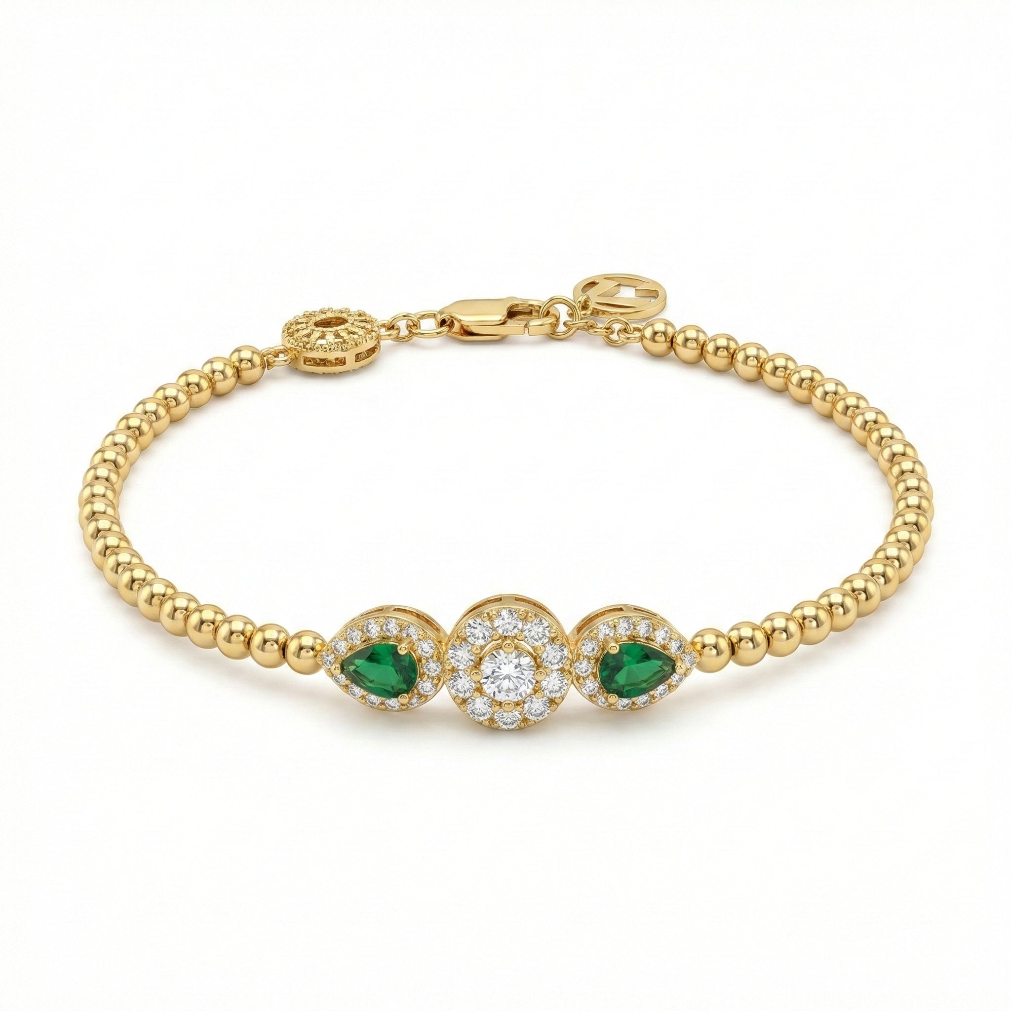 Gold bracelet with emerald and diamond accents on a white background