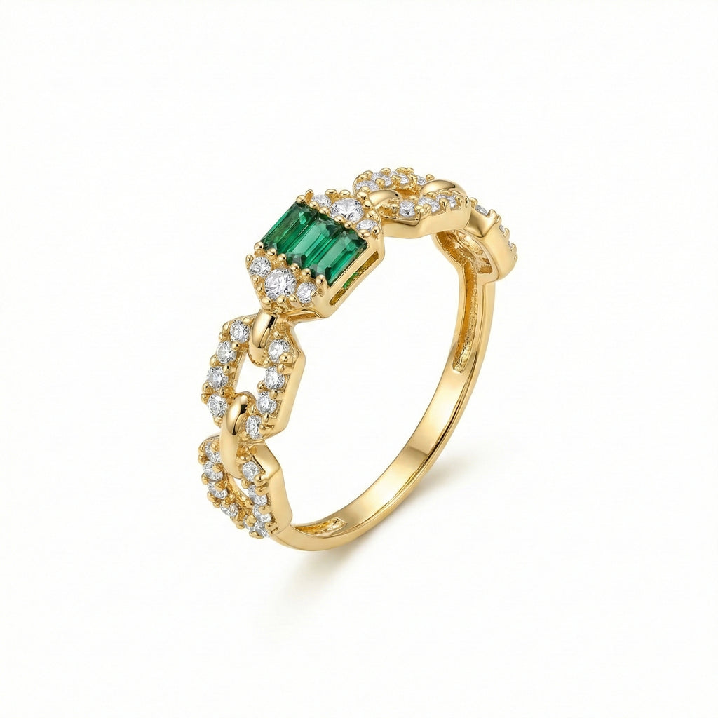 Gold ring with emerald and diamonds on a white background