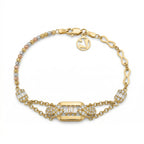 Lazurde 18k yellow gold bracelet on a pure white background. The piece features a central rectangular gold plaque set with three vertical baguette-cut diamonds and pavé-set accents, connected to a chain of tri-color gold beads and infinity-shaped links with a signature Lazurde logo charm.
