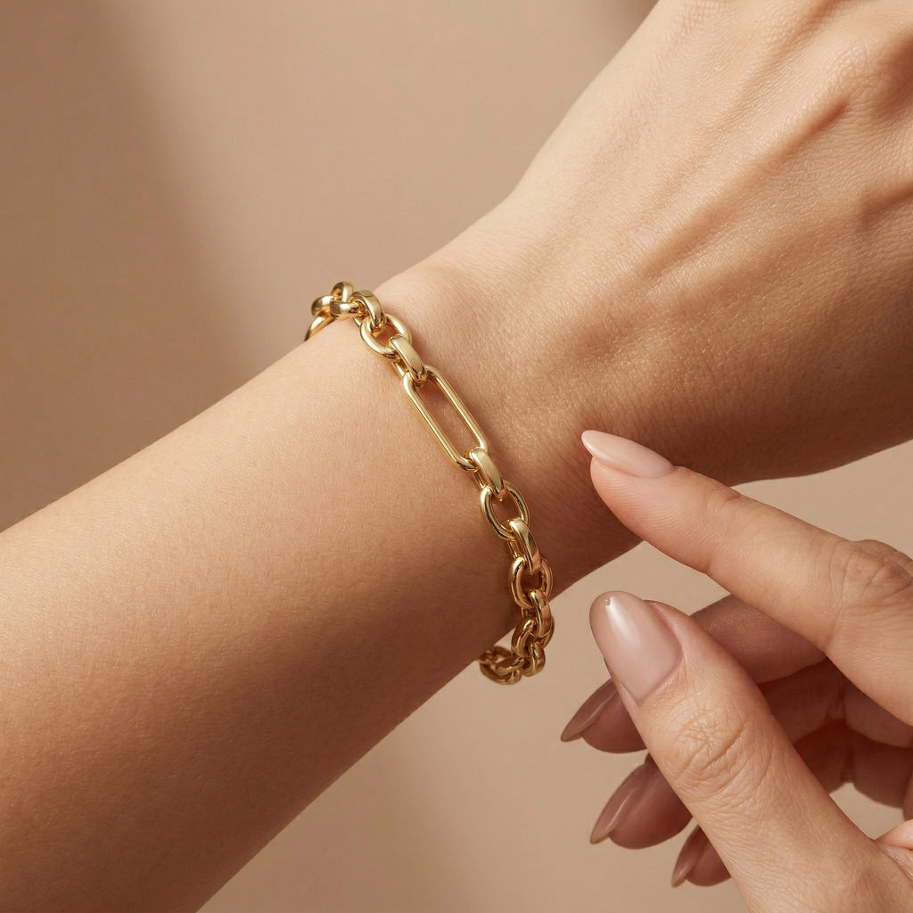 A luxury 4K close-up of the Wassef 18k yellow gold Gourmet bracelet on a wrist, featuring a gentle touch to showcase the refined texture and high-shine gold links.