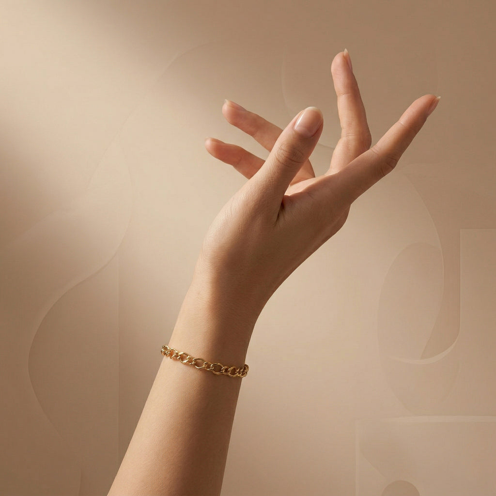 A luxury editorial-style photo of the 3B 18k yellow gold Gourmet bracelet on a feminine wrist with an elegant sculptural hand pose, set against a nude gradient background with subtle abstract shapes.