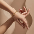Wassef 18k yellow gold Gourmet bracelet styled on a feminine wrist with an elegant sculptural hand pose.