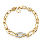 A top-down, ultra-realistic product photograph of a Lazurde 18k yellow gold link bracelet isolated on a pure white background. The bracelet is arranged in a circle, cleanly displaying its elongated gold links, twisted pave-set centerpiece, and the Lazurde logo charm near the clasp.