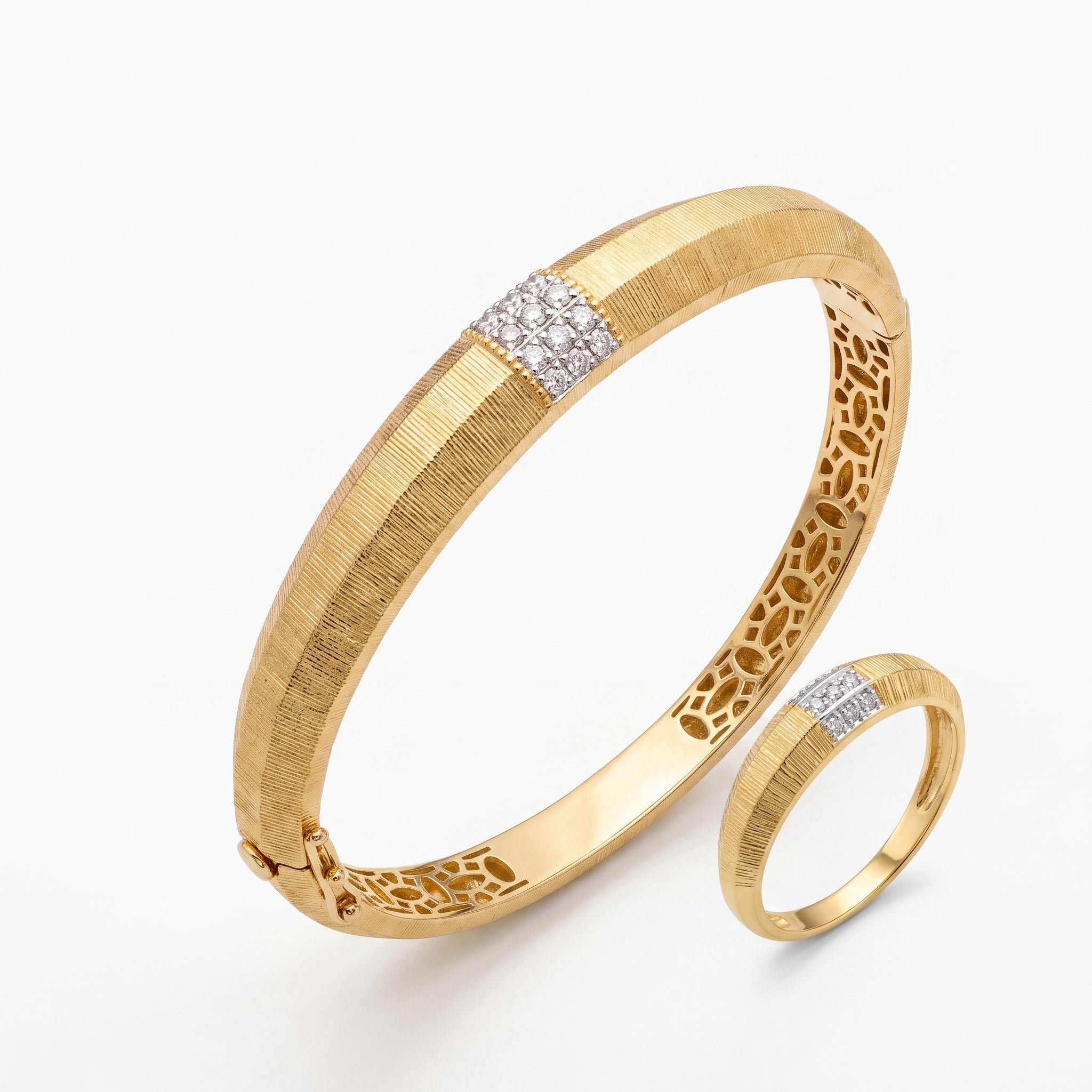 Matching L'azurde 18k yellow gold set including a textured bangle and a slim-bottomed ring, isolated on a pure white background.	طقم لازوردي من الذهب الأصفر عيار 18 يضم إسورة بارزة الملمس وخاتم مطابق نحيف من الأسفل، معزول على خلفية بيضاء نقية.