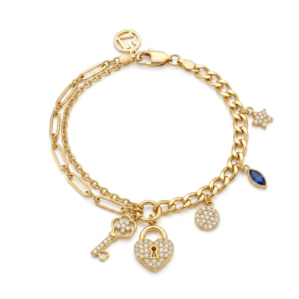L'azurde 8.60g gold charm bracelet on a pure white background, featuring a double chain with stone-paved heart padlock, key, star, and blue stone charms.سوار تعليقات ذهبي من لازوردي بوزن 8.60 غرام على خلفية بيضاء نقية، يتميز بسلسلة مزدوجة مع تعليقات قفل القلب المرصع، المفتاح، النجمة، والحجر الأزرق.