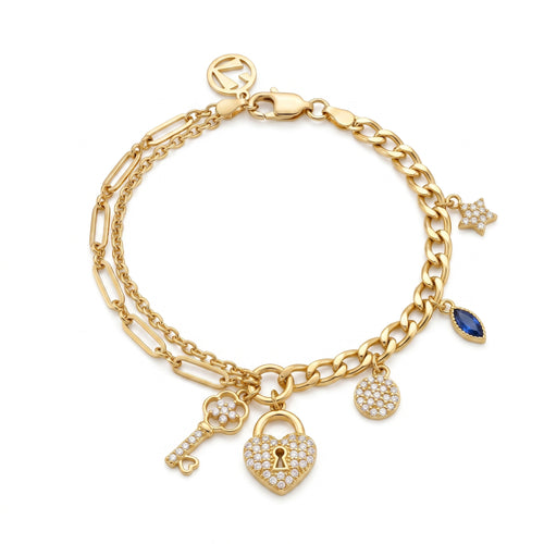 L'azurde 8.60g gold charm bracelet on a pure white background, featuring a double chain with stone-paved heart padlock, key, star, and blue stone charms.سوار تعليقات ذهبي من لازوردي بوزن 8.60 غرام على خلفية بيضاء نقية، يتميز بسلسلة مزدوجة مع تعليقات قفل القلب المرصع، المفتاح، النجمة، والحجر الأزرق.