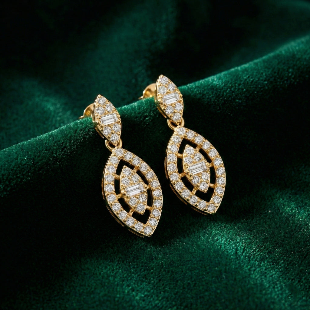 Gold earrings with diamond accents on a green velvet background