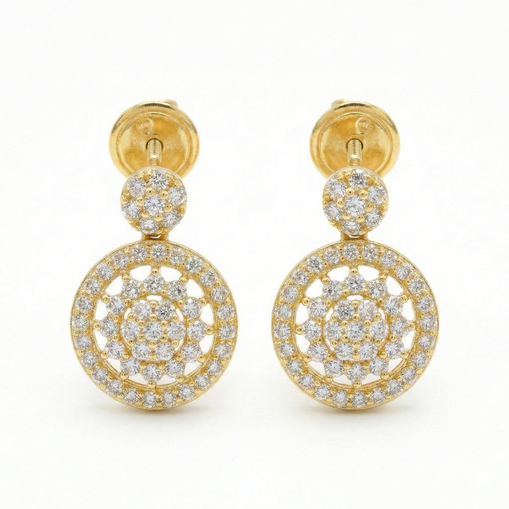 Gold earrings with circular designs and clear stones on a white background
