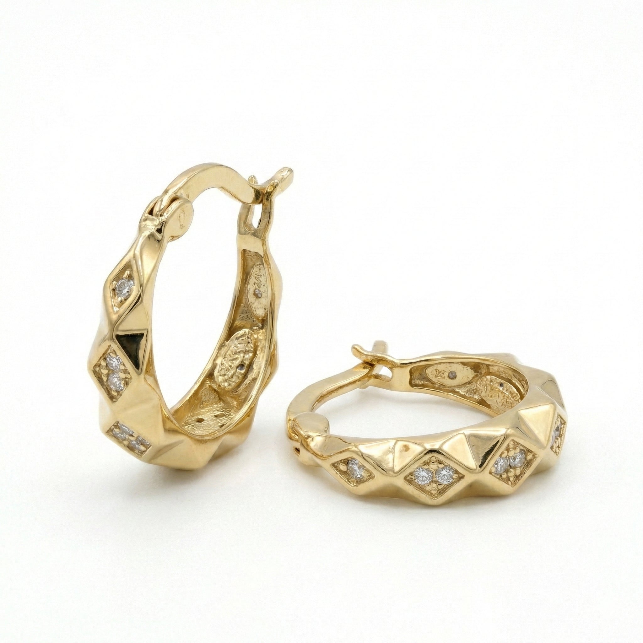 Gold hoop earrings with diamond accents on a white background