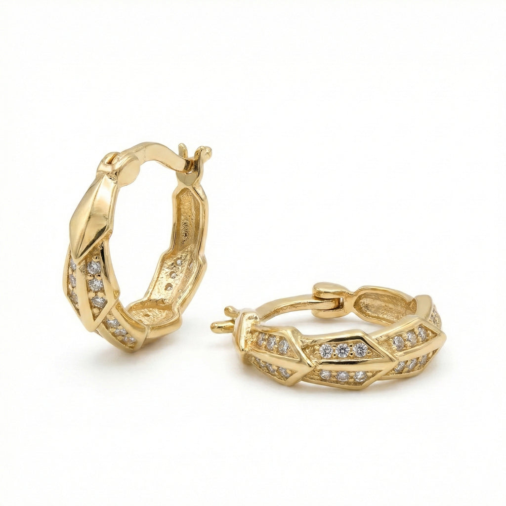 Gold hoop earrings with diamond accents on a white background