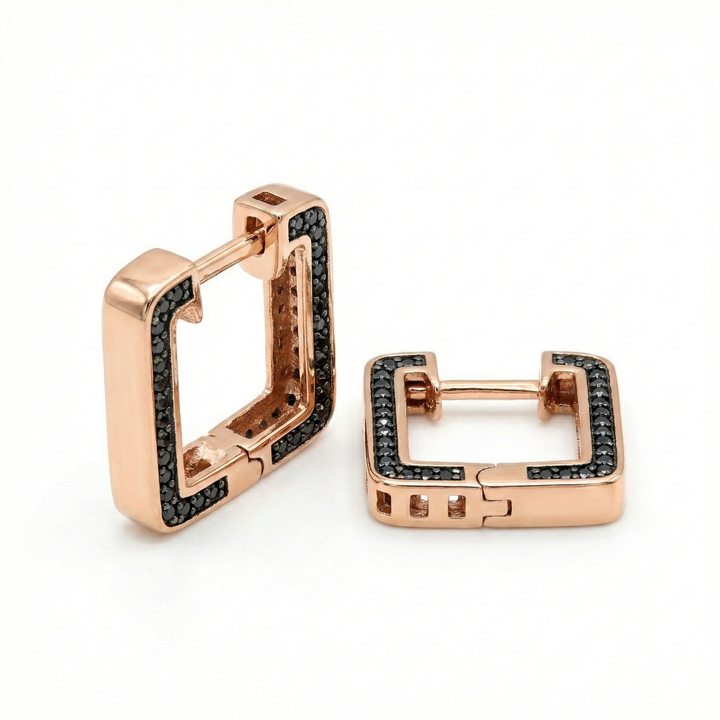 Rose gold hoop earrings with black gemstones on a white background