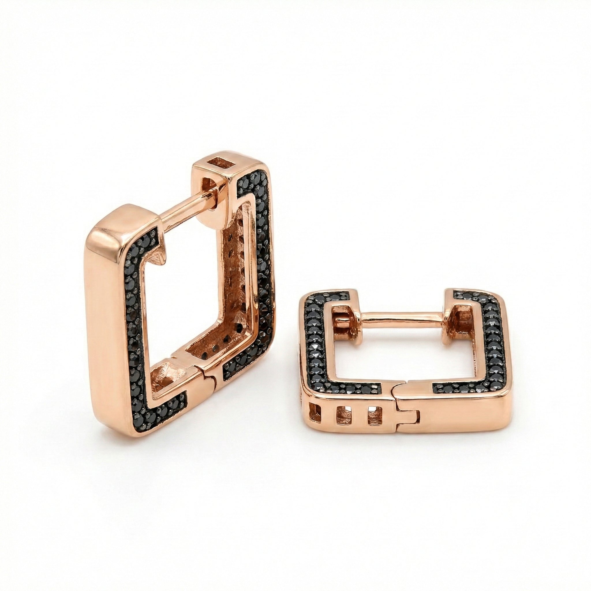 Rose gold hoop earrings with black gemstones on a white background