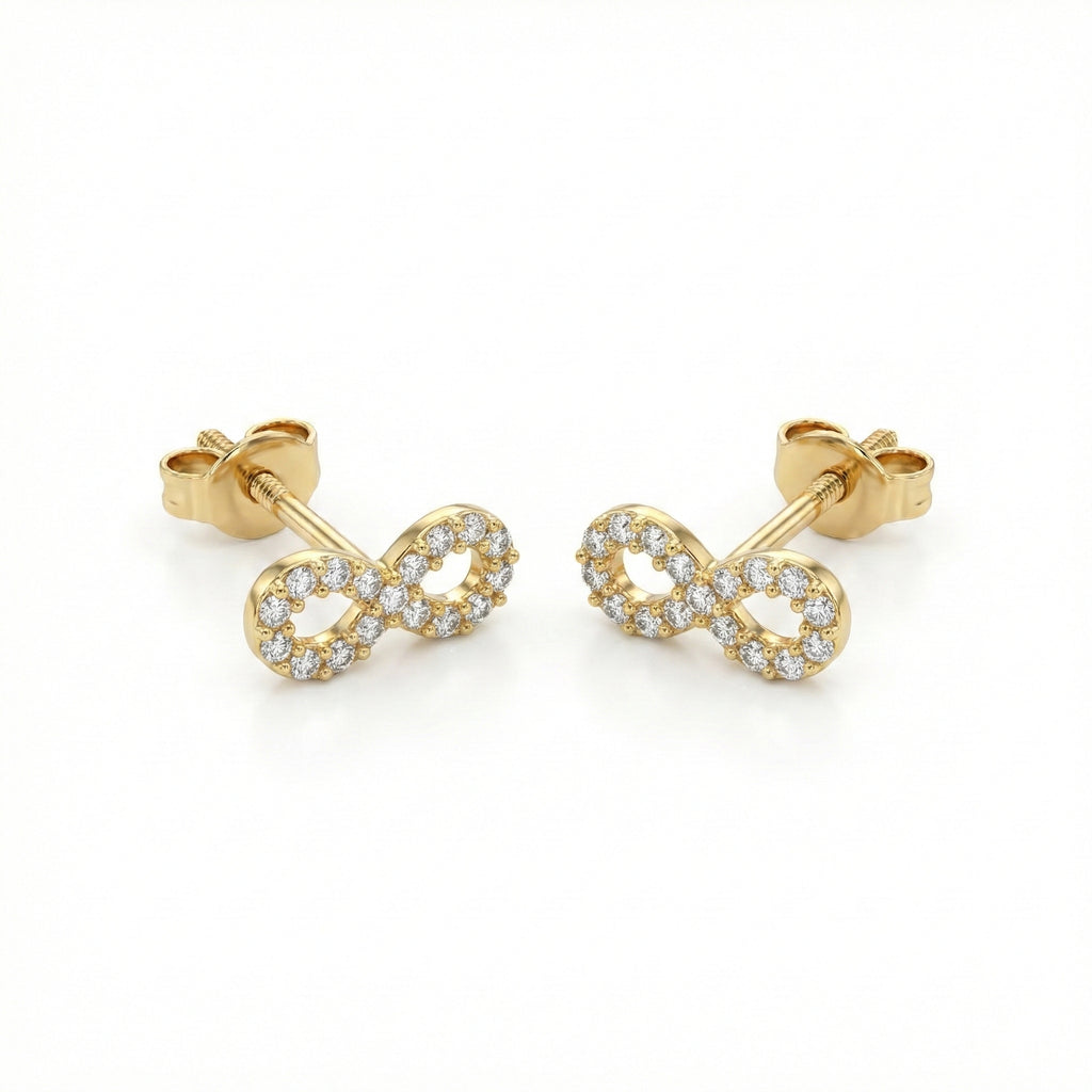 Gold infinity symbol earrings with clear stones on a white background