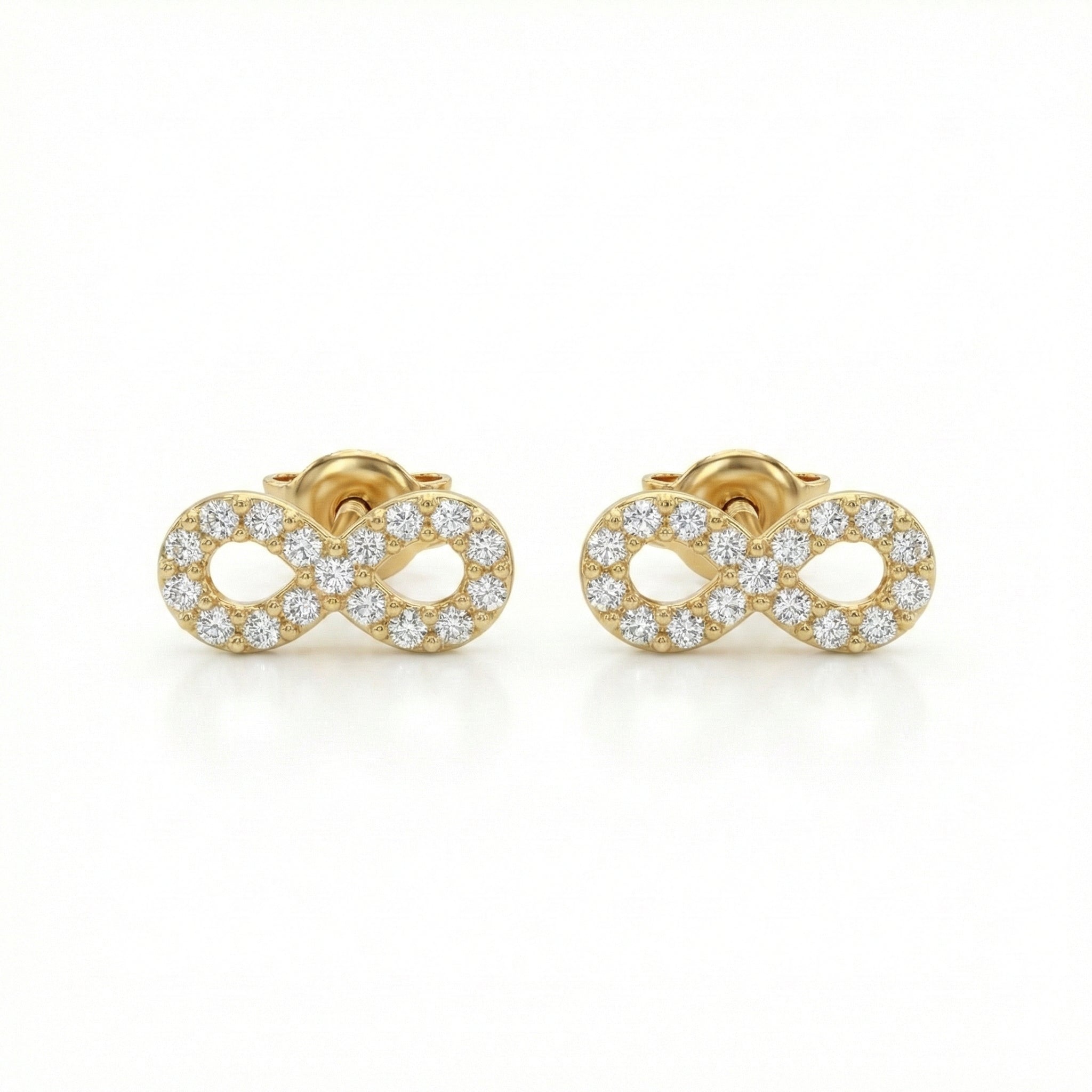 Gold infinity symbol earrings with clear gemstones on a white background