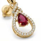 Extreme close-up of a Lazurde 18k yellow gold earring, highlighting the intricate craftsmanship of the pave diamond accents and the deep red hues of the central teardrop crimson stone.