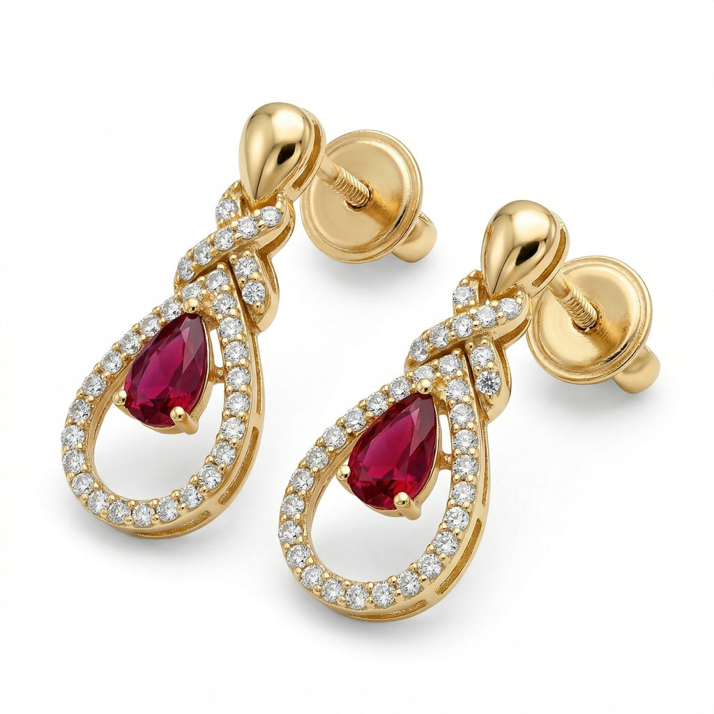 Lazurde 18k yellow gold drop earrings featuring a pear-shaped crimson center stone surrounded by a diamond-accented halo and crossover design, presented on a pure white background.