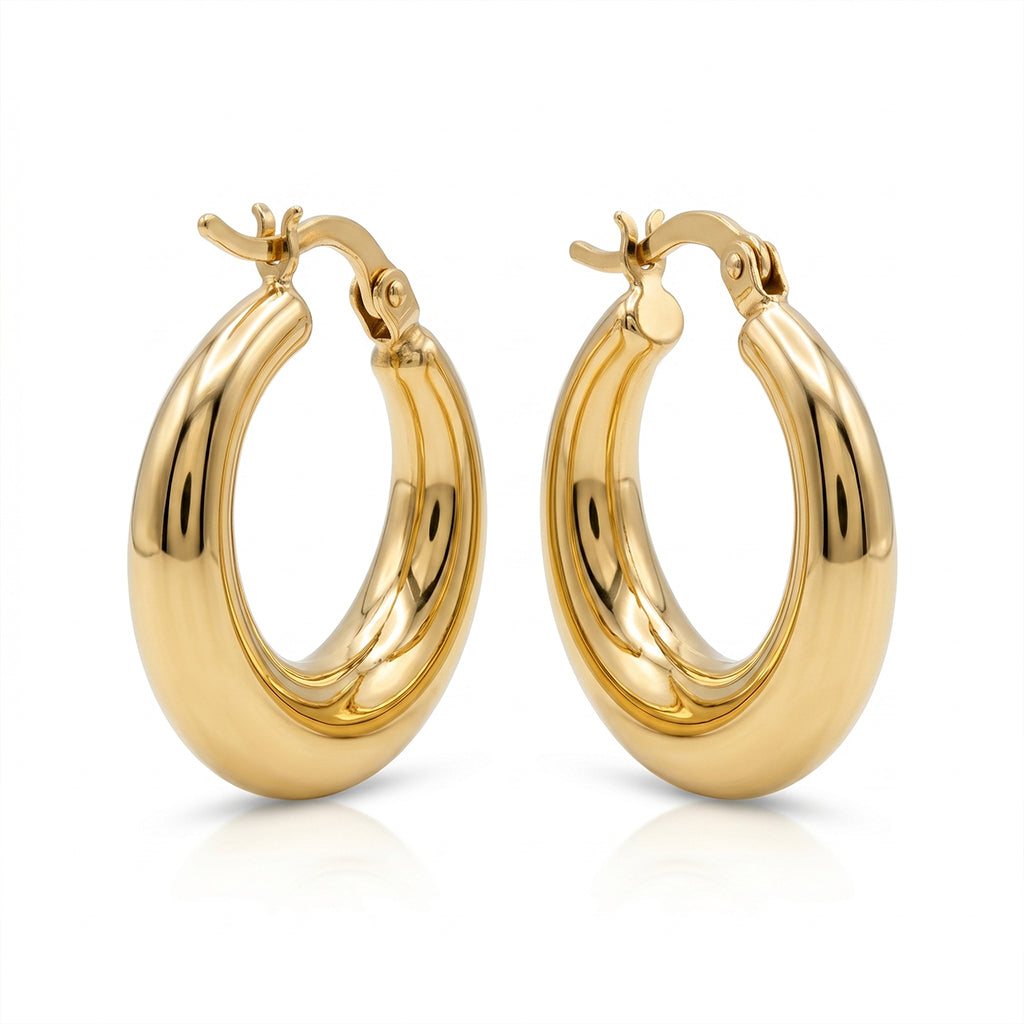 A symmetrical studio product photograph of a pair of thick, polished gold hoop earrings. They are isolated on a pure white background with their hinges and clasps clearly visible at the top, and a subtle reflection below.
