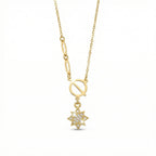 Gold necklace with a star-shaped pendant on a white background