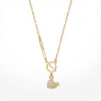 Gold necklace with a heart-shaped pendant on a white background