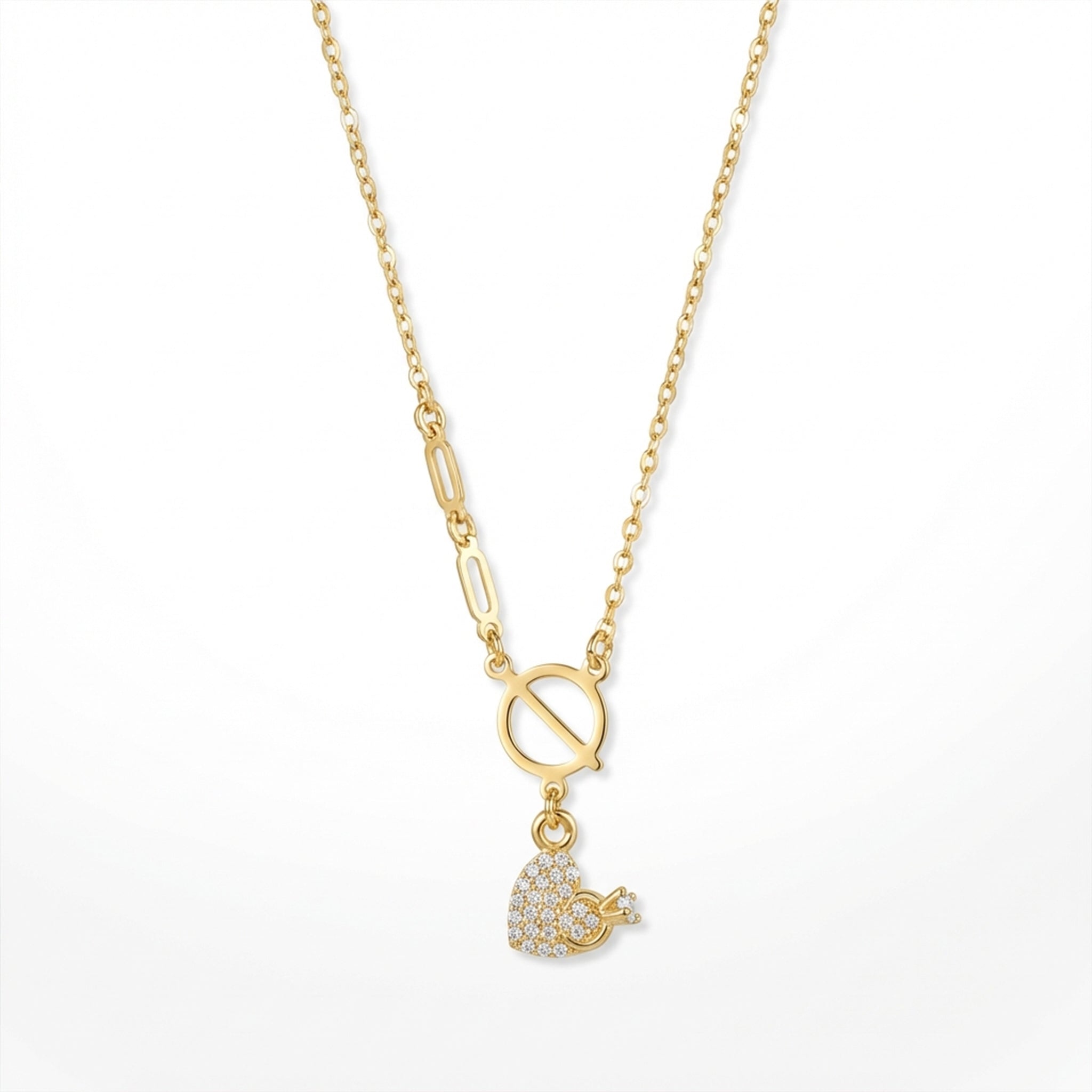 Gold necklace with a heart-shaped pendant on a white background