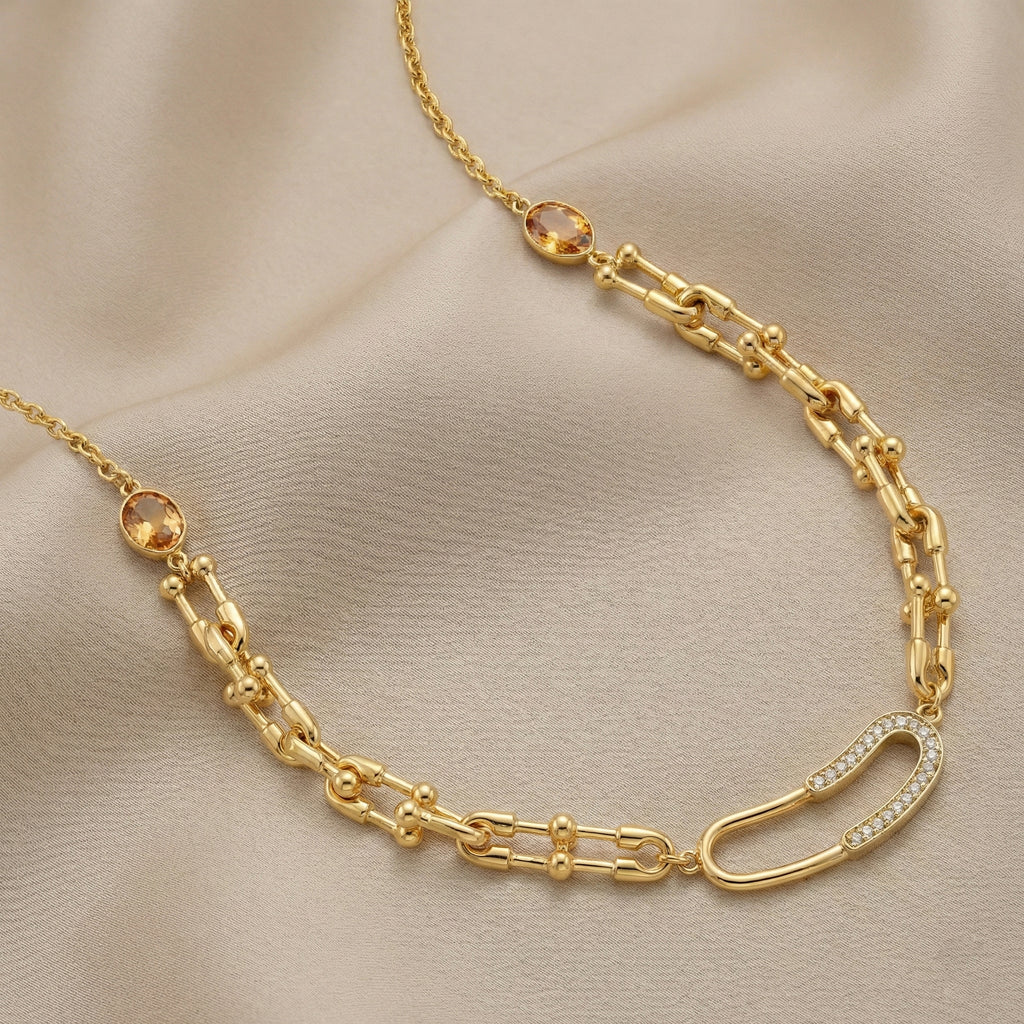 Gold chain necklace on a beige fabric background
