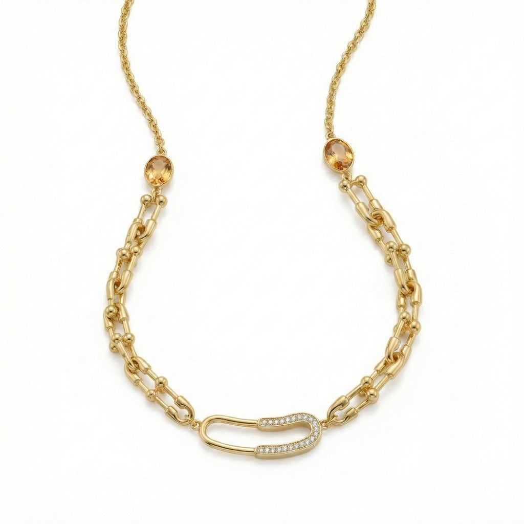 Gold chain necklace with a unique clasp on a white background