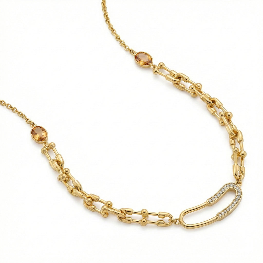 Gold chain necklace with gemstone beads on a white background