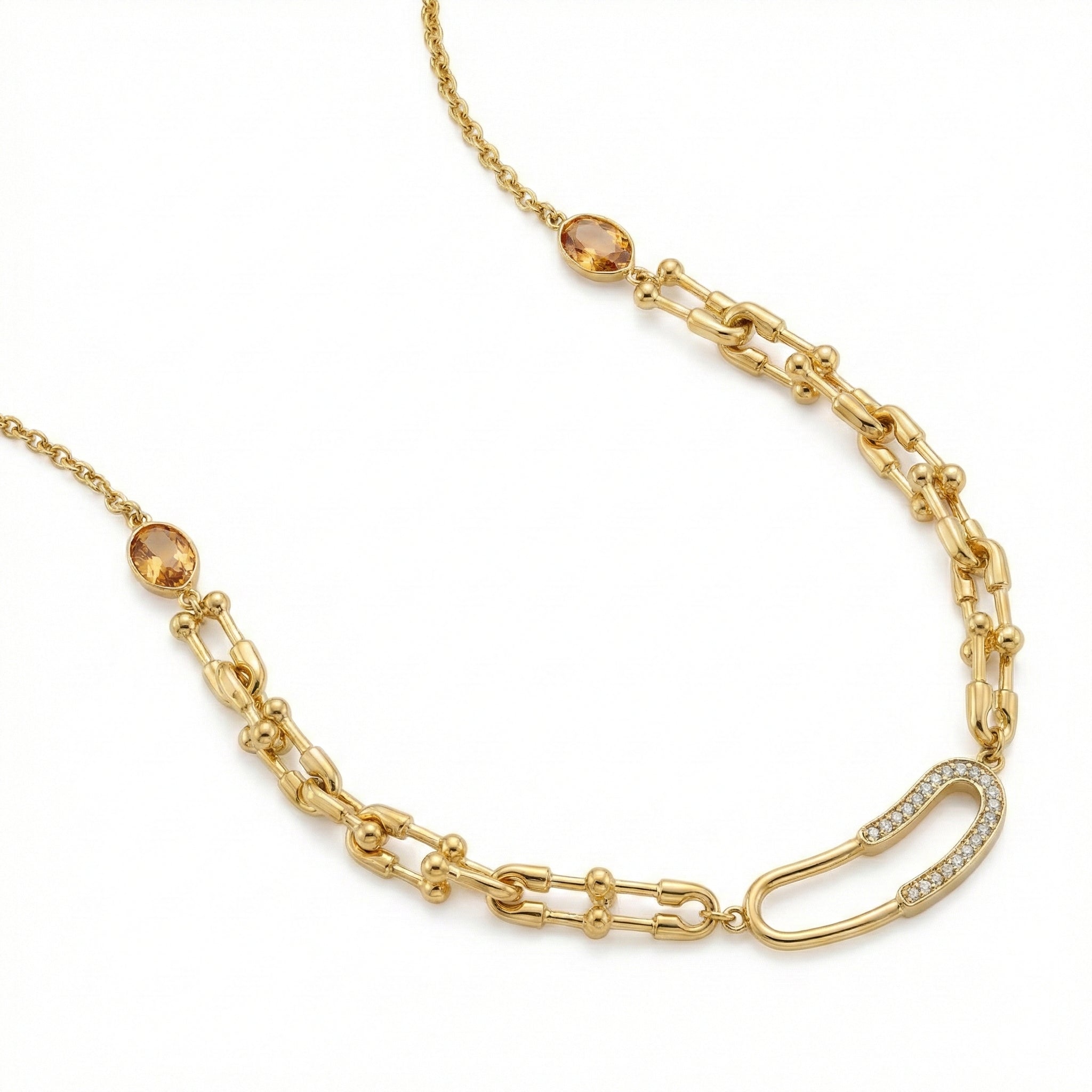 Gold chain necklace with gemstone beads on a white background