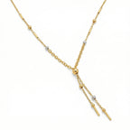 Gold necklace with small beads and bars on a white background