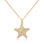 18k yellow gold starfish pendant necklace by Remas Gold featuring delicate pave detailing against a pure white background.
سلسلة دهب عيار 18 بدلاية نجمة البحر من ريماس جولد بتفاصيل فصوص لامعة على خلفية بيضاء نقية.