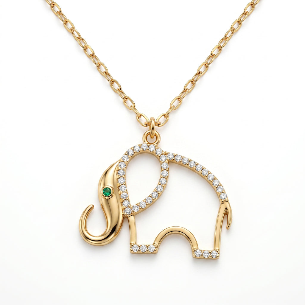 A professional studio shot of a gold necklace with an openwork elephant pendant, isolated against a solid white background. The elephant's curved back is paved with small sparkling diamonds, and its eye is a tiny green emerald.
لقطة استوديو احترافية لقلادة ذهبية مع دلاية مفرغة على شكل فيل، معزولة على خلفية بيضاء سادة. يزدان منحنى ظهر الفيل بقطع ألماس صغيرة براقة، وعينه عبارة عن زمردة خضراء صغيرة.