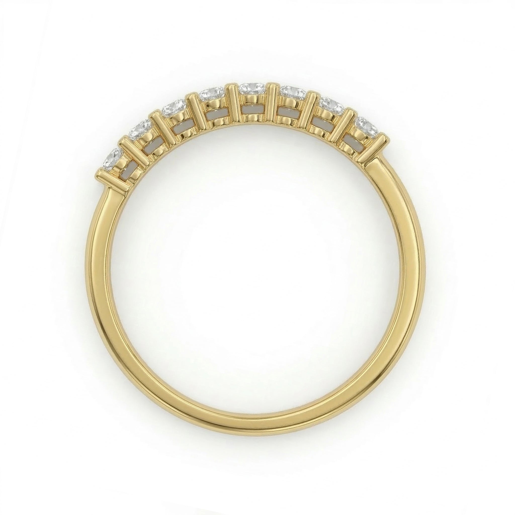 Top-down view of the Fine Gold 18k yellow gold wedding promise ring from The Forever Edit category, featuring seven brilliant stones set on a delicate band, lying flat against a pure white background.