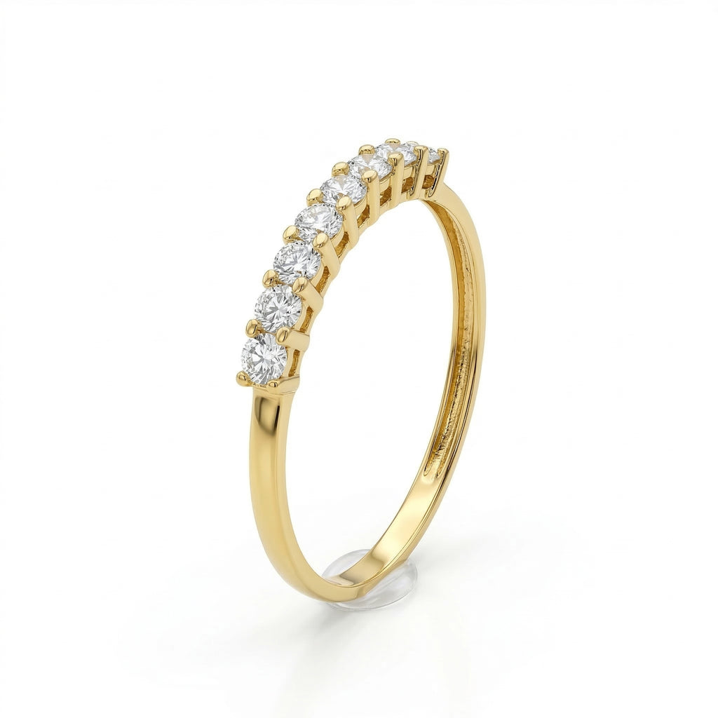 Fine Gold 18k yellow gold wedding promise ring from The Forever Edit category, featuring seven brilliant stones set on a delicate band against a pure white background