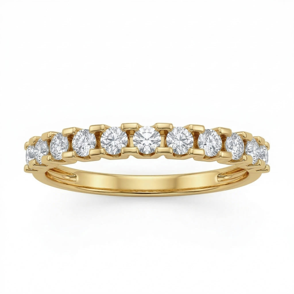 Front view of a Fine Gold 18k yellow gold wedding promise ring lying flat on a pure white background. The ring belongs to The Forever Edit category and features a delicate half-eternity band set with 11 brilliant round stones.