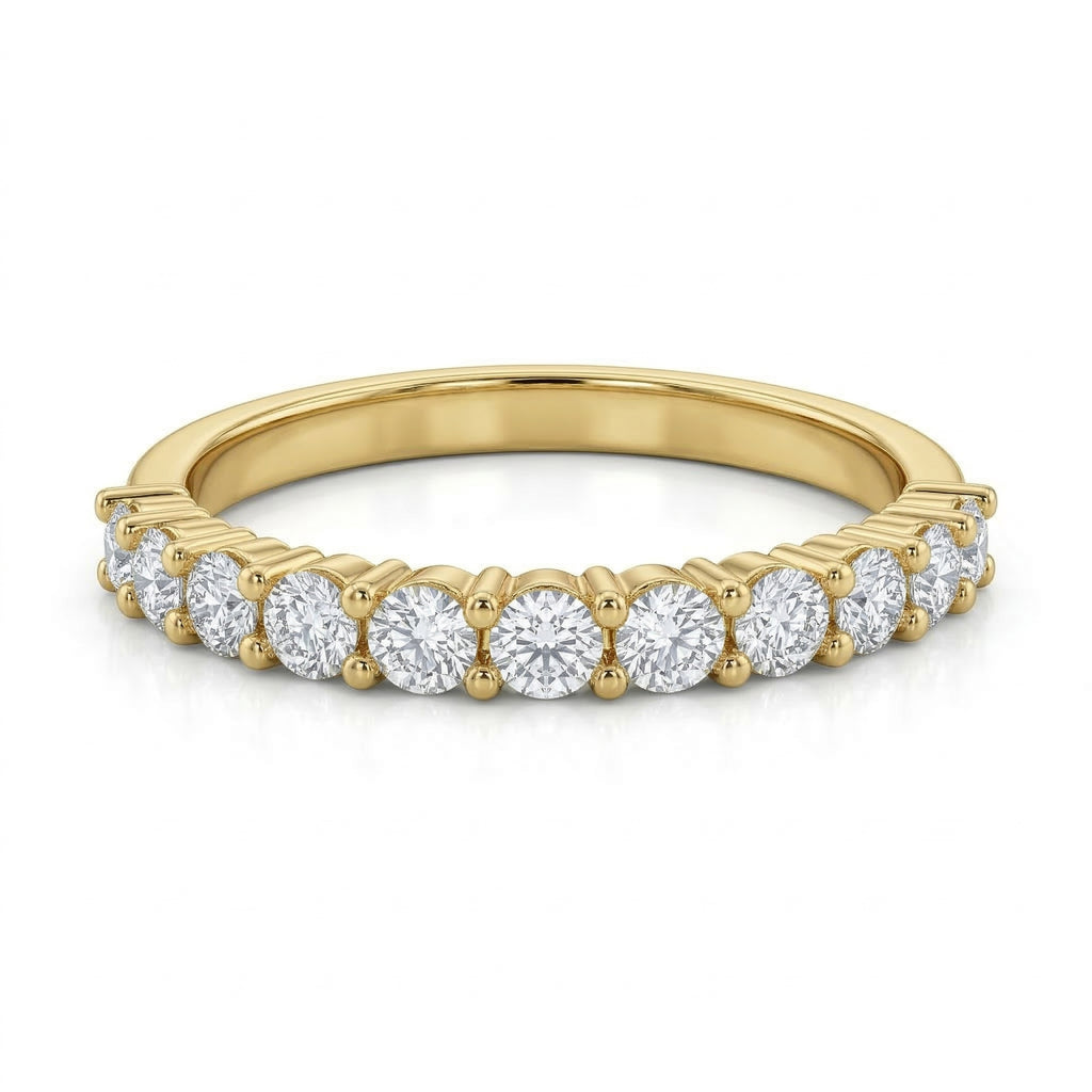 Front view of a Remas 18k yellow gold promise ring lying flat against a pure white background. Belonging to The Forever Edit collection, the ring showcases 13 sparkling stones beautifully aligned along a delicate gold band.