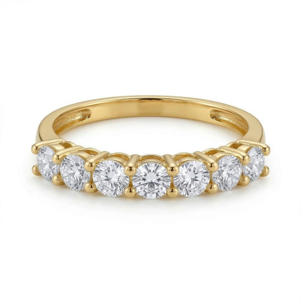 Fine Gold 18k yellow gold promise ring from The Forever Edit collection, showcasing seven brilliant stones, lying flat and viewed straight-on against a pure white background to highlight the band's structure.