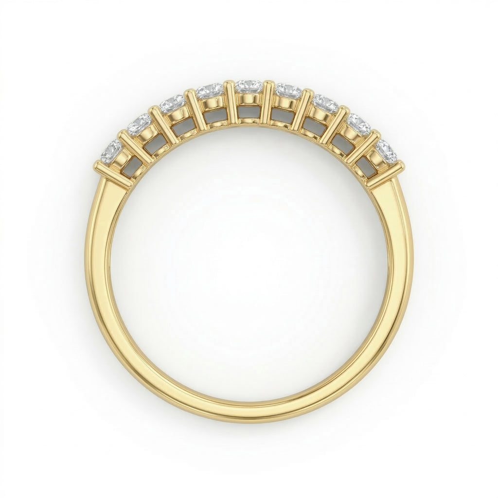 Top-down view of the Fine Gold 18k yellow gold wedding promise ring lying flat on a pure white background, highlighting the nine-stone setting of this elegant piece from The Forever Edit category.