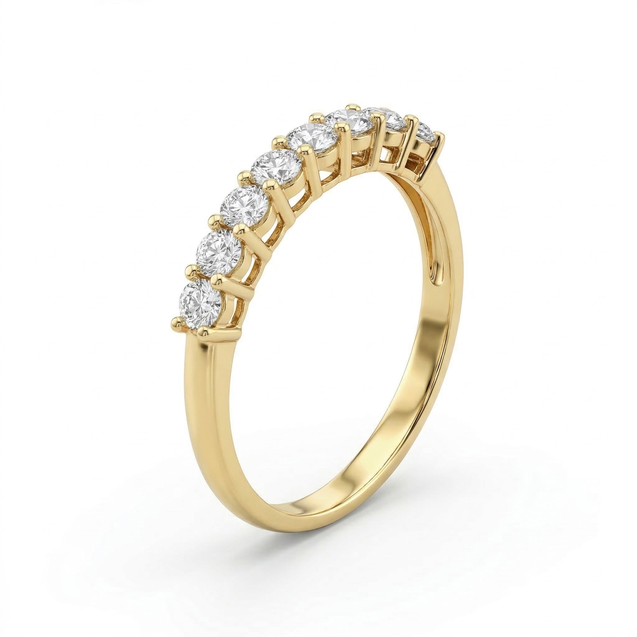 Angled profile of the Fine Gold 18k yellow gold wedding promise ring from The Forever Edit category, showcasing a delicate band set with nine brilliant stones against a pure white background.