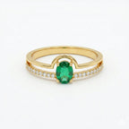 Gold ring with a green gemstone and small white stones on a white background