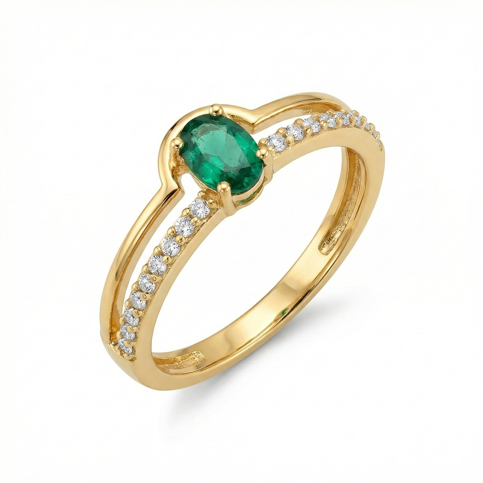 Gold ring with a green gemstone and diamond accents on a white background