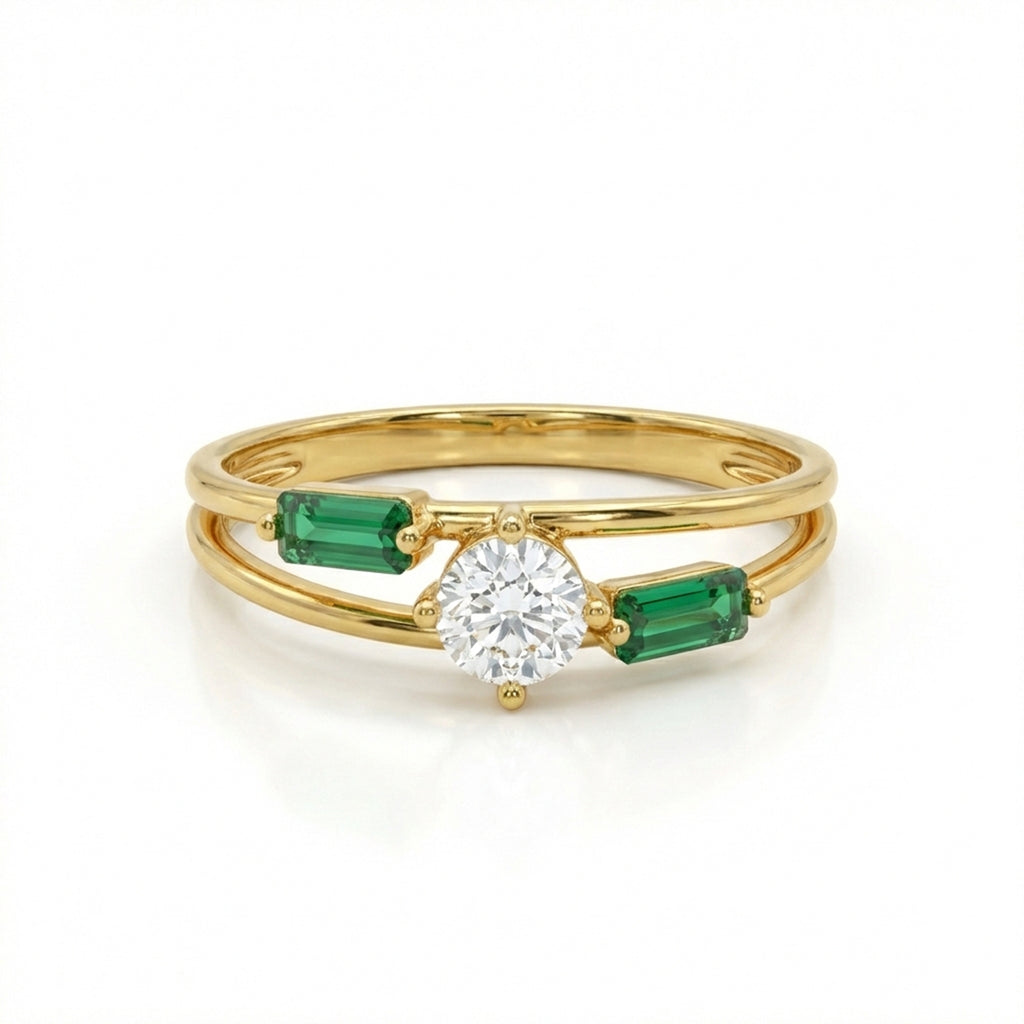 Gold ring with a diamond and emerald stones on a white background