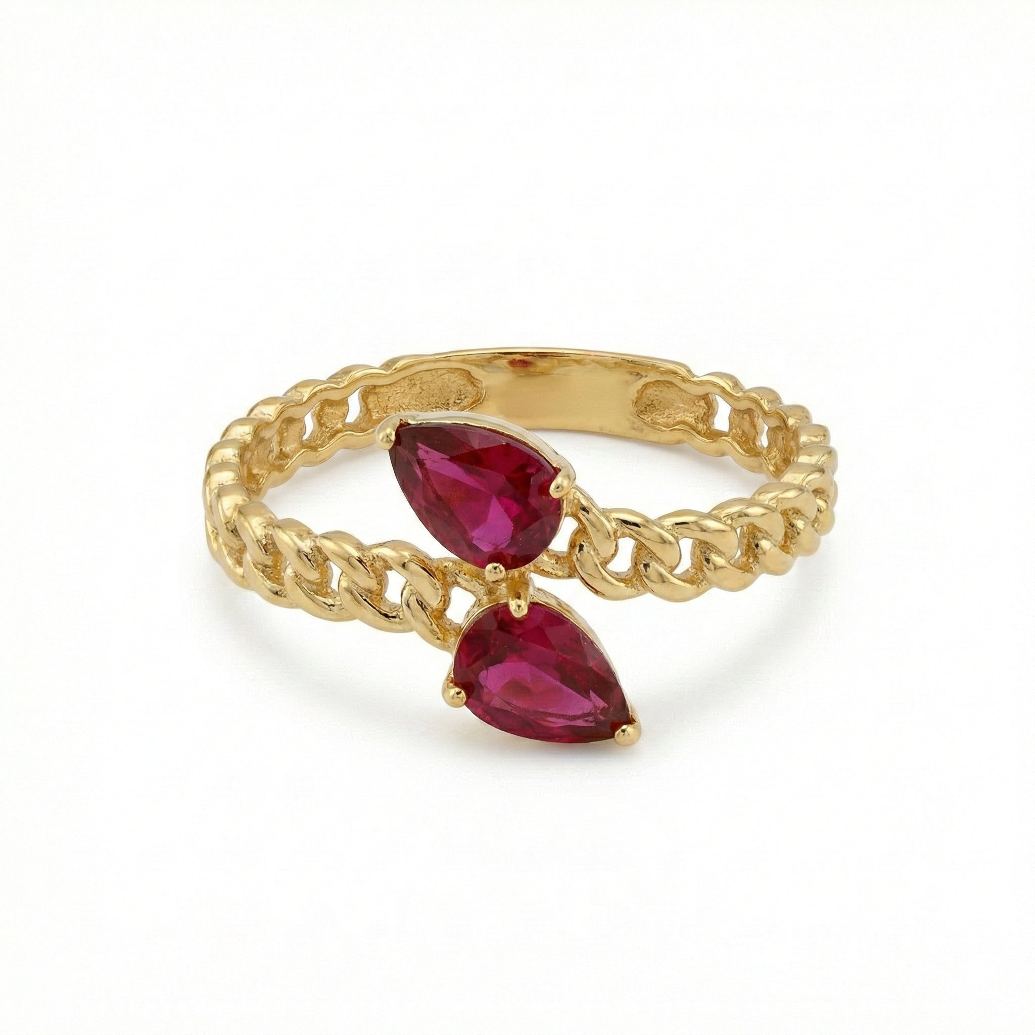 Gold chain ring with red gemstones on a white background