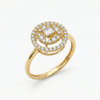 Gold ring with diamond accents on a white background